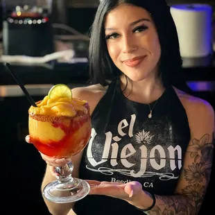 a woman holding a drink