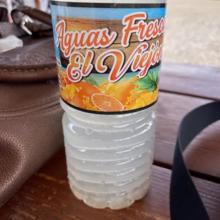 a bottle of water on a picnic table