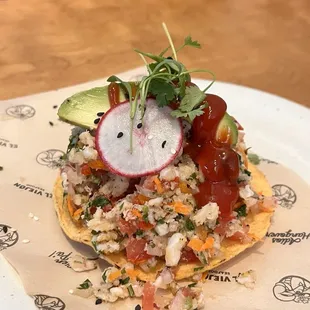 Fish ceviche on a tostada with everything.