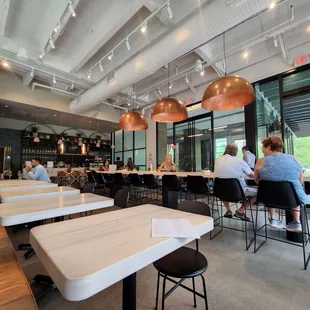 people sitting at tables in a restaurant