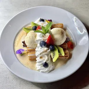 a plate of fruit and ice cream