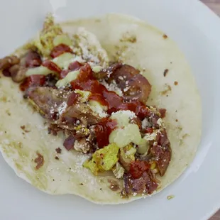 Breakfast taco: egg, protein of your choice, mozzarella cheese and cotija cheese.