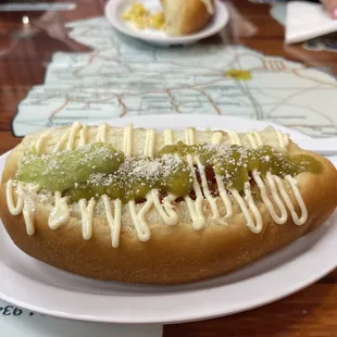Classic Sonoran hot dog with my terrible sauce skills where I unevenly out avocado sauce and sals verde.