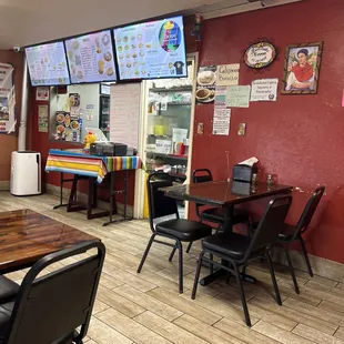 Inside El Zarape  restaurant, the wall are red with Mexican ornaments. And a full menu in front of cashier.