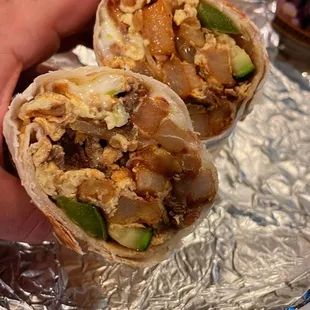 a hand holding a burrito