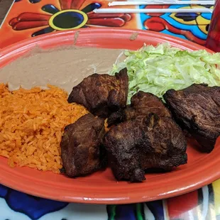 Carnitas with lettuce, beans and rice.