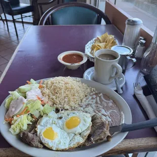 #14 Bistec Montado, top sirloin topped with 2 fried eggs, rice and beans