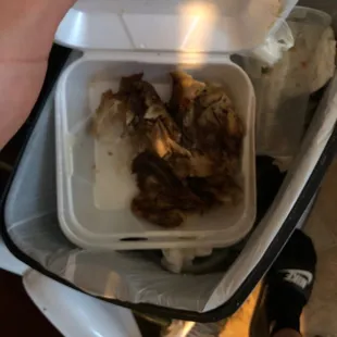 a person holding a container of food
