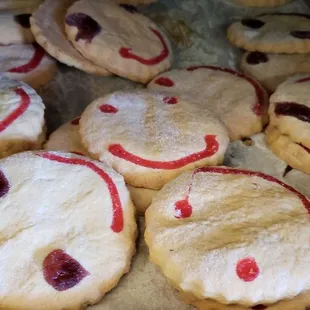 a tray of cookies with smiley faces