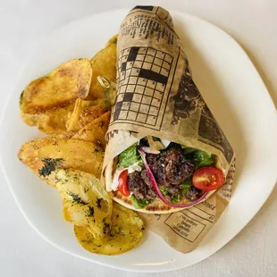 Beef and lamb kofta sandwich with tahini sauce and house herbed chips