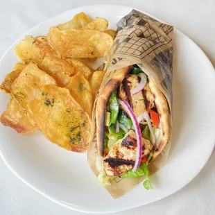 Chicken Shawarma sandwich with tzatziki sauce served with our herbed house chips