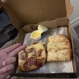 two slices of pizza in a box