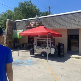 a man standing in front of a food truck