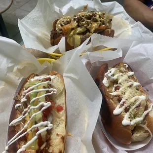 two hotdogs with condiments