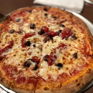 a pizza with olives and cheese