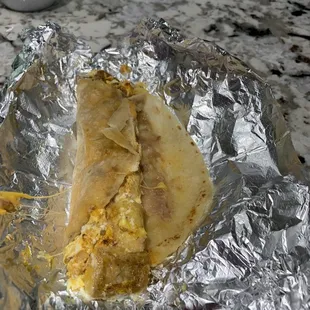 Potato and Eggs Taco Breakfast - added refried beans and cheese -  Solid but it  needed some seasoning