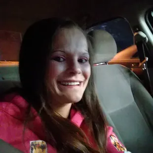 a smiling woman in a car