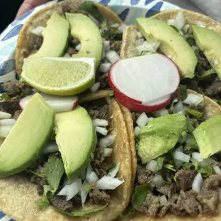 Carne asada tacos with additional avocado slices