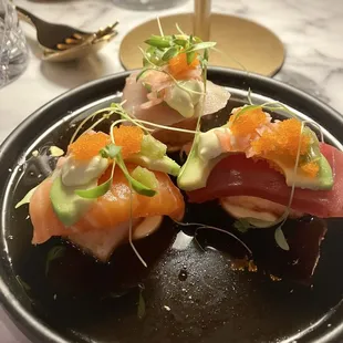 Crispy rice nigiri with one each of salmon, tuna, hamachi