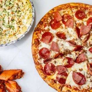 a pepperoni pizza and hot wings