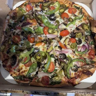 Small Veggie Pizza with tomatoes and spinach added