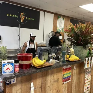 a man standing behind a counter in a store