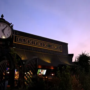 a clock in front of a restaurant