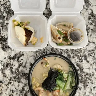 two takeout containers with food in them
