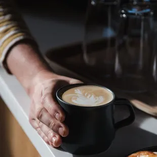 a person holding a cup of coffee