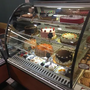 a display case of cakes and pastries