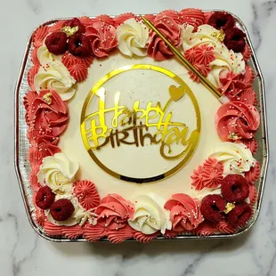 White cake with white buttercream frosting &amp; raspberries.