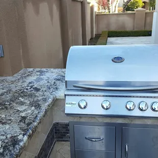 a stainless steel outdoor kitchen