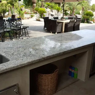 outdoor kitchen with table and chairs