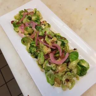 Maple Bourbon Glazed Brussel Sprouts: Sautéed with applewood smoked bacon, topped with pickled onion and maple syrup