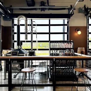 a view of a bar with stools and tables