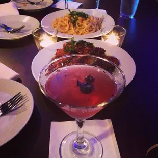 Pasta, chicken wings, and one of their signature drinks called elemental