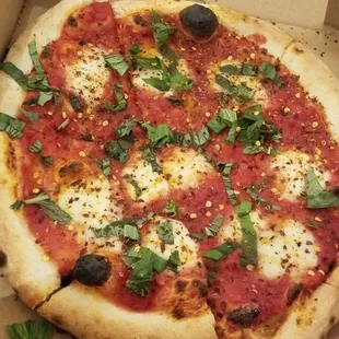 Margherita pizza covered in chili flakes