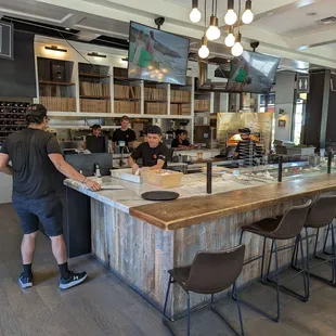a man standing at a counter in a restaurant