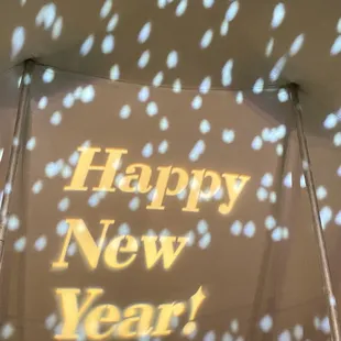 the words happy new year projected on the ceiling