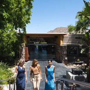 Three women walking up the stairs outside elements restaurant.