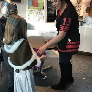 Elements Employee giving out candies to kids during Halloween