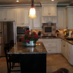 a kitchen with white cabinets and granite countertops