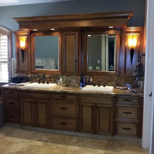 a bathroom with two sinks and a large mirror