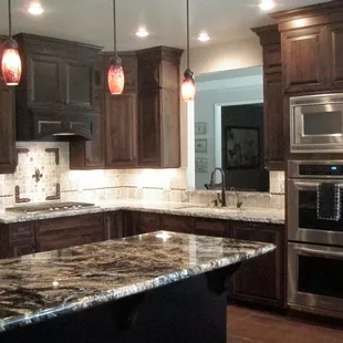 a kitchen with granite countertops and stainless steel appliances