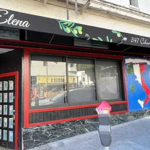 the front of a restaurant with a parking meter in front of it