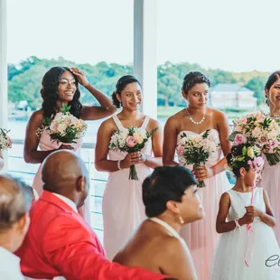 Bridesmaids are all dressed up and happy for the Bride
