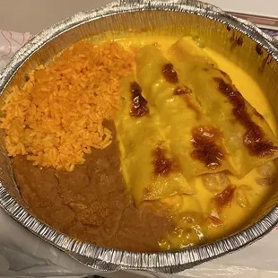 Shrimp enchiladas, rice, and beans.