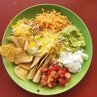 a green plate with tortillas, guacamole, sour sour sour sour sour sour sour sour