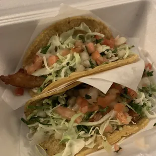 Fried fish taco on top and grilled fish taco on bottom