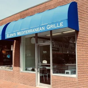 Façade with blue awning